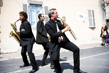 Image showing Three musicians in the street.