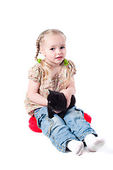 Image showing Little girl playing with kitten