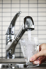 Image showing Filling glass of tap water