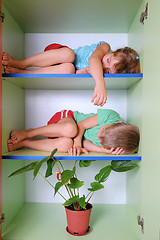 Image showing tired kids in a closet