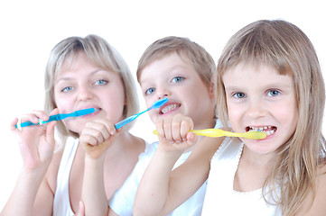 Image showing family cleaning teeth