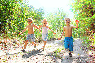 Image showing happy kids running in the woods