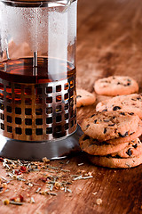 Image showing french press with hot tea and fresh baked cookies