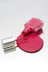 Image showing Nail Polish Spilling on a Mirror with the Brush Facing the Bottl