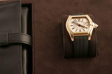 Image showing gold watch with black strap 