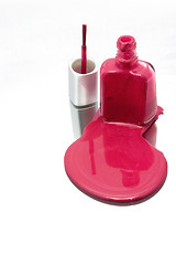 Image showing Nail Polish Spilling on a Mirror with the Brush Standing