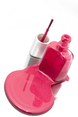 Image showing Nail Polish Spilling on a Mirror with the Brush Standing at an A