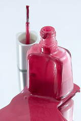 Image showing Isolated Nail Polish Spilling on a Mirror with the Brush