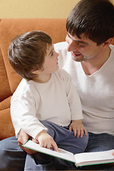 Image showing Father reading book to daughter