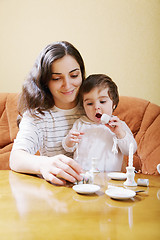 Image showing Smiling mummy playing with daughter