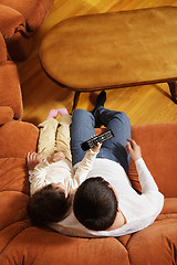 Image showing Father watching television with daughter