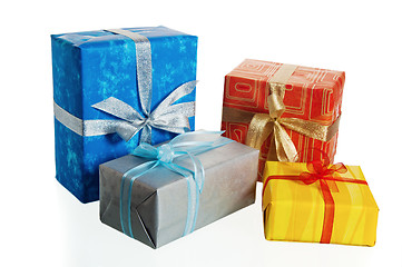 Image showing Multi-coloured boxes with gifts, it is isolated on white