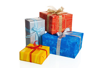 Image showing Multi-coloured boxes with gifts, it is isolated on white