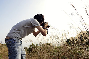 Image showing nature photographer taking pictures outdoors