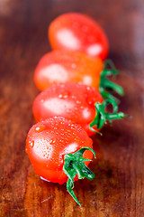 Image showing four wet tomatoes