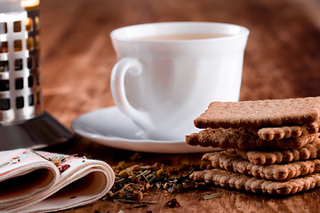 Image showing french press, cup of fresh herbal tea and some cookies 