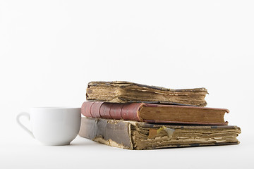 Image showing Coffee cup and three old book