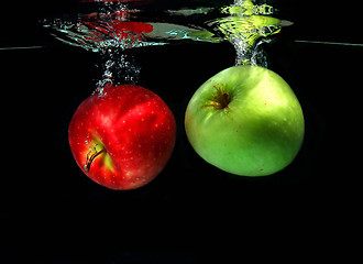 Image showing Two apples falling into water