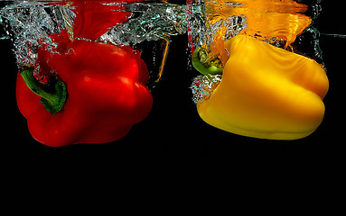 Image showing Peppers falling into water