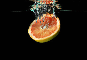 Image showing Grapefruit  falling into water