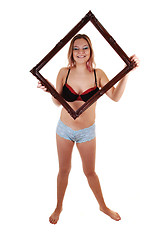Image showing Girl holding frame up.