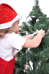 Image showing child decorating Christmas tree