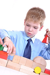 Image showing schoolboy playing with bricks