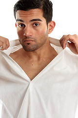 Image showing Handsome man removing shirt