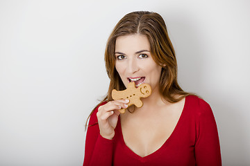 Image showing Bitting a Gingerbread cookie