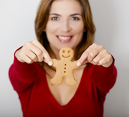 Image showing Holding a Gingerbread cookie