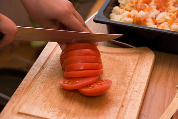 Image showing Cutting red tomato