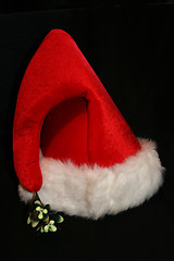 Image showing A bright red Santa hat shot on black