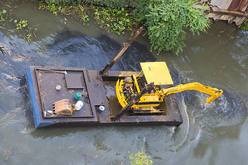 Image showing Small dredge doing maintenance on a canal