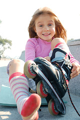 Image showing child putting on her rollerblade skate