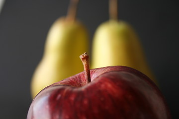 Image showing  one apple tow pears