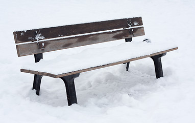 Image showing Snow covered bench