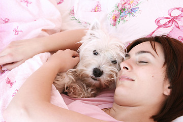 Image showing Dog sleeping on bed 