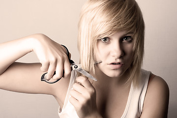 Image showing young woman with scissors