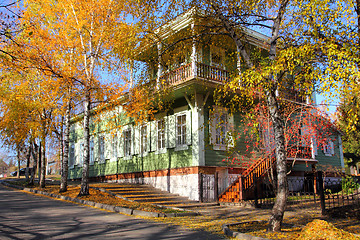 Image showing wooden house between autumn trees