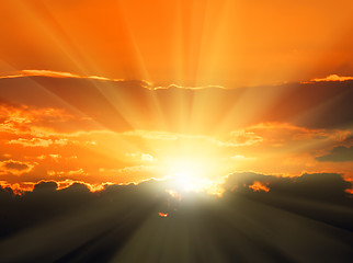 Image showing orange sunset with sunbeams