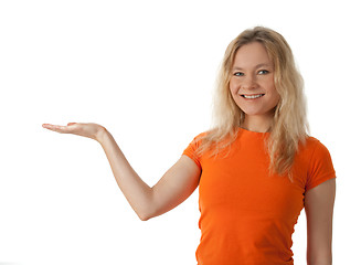 Image showing Smiling young woman holding her hand palm up