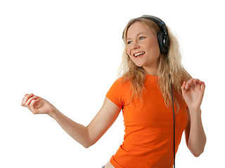 Image showing Happy girl listening to music and dancing