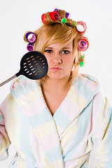 Image showing funny housewife with curlers and skimmer