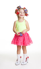 Image showing Little girl play fashion in mothers shoes and rollers