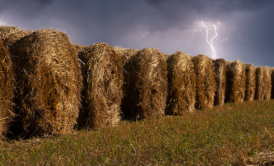 Image showing haystacks in the field during the thunderstorm