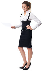 Image showing Business woman laughing holding a document