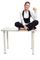 Image showing Business woman sit on table with apple