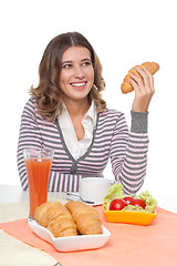 Image showing Happy woman with croissant