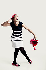 Image showing Portrait of a beautiful fashion woman posing and holding a red w