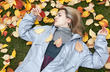 Image showing Beautiful girl rests upon autumn sheet